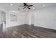 Bright living room with wood-look flooring, recessed lighting, and arched doorways creating an open and airy space at 11319 82Nd E St, Parrish, FL 34219