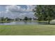 Scenic view of a pond surrounded by well-maintained homes and lush greenery at 11319 82Nd E St, Parrish, FL 34219
