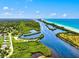 Stunning aerial view of lush coastal landscapes with winding waterways and pristine shoreline at 13644 Brilliante Dr, Venice, FL 34293