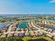 Expansive aerial shot of a residential neighborhood featuring waterfront homes, lush landscaping, and serene lakes at 13644 Brilliante Dr, Venice, FL 34293