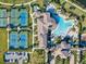 Aerial view of community featuring tennis courts, clubhouse, parking, and a pool at 13644 Brilliante Dr, Venice, FL 34293
