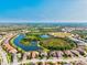 Stunning aerial view of a Primary-planned community with lakes and lush landscaping under a clear blue sky at 13644 Brilliante Dr, Venice, FL 34293
