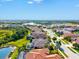 Beautiful aerial view of a community with winding roads, a serene lake, and well-manicured lawns at 13644 Brilliante Dr, Venice, FL 34293
