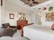 Bright bedroom showcases neutral carpet, dark wood furniture, a ceiling fan, and natural light at 13644 Brilliante Dr, Venice, FL 34293