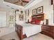 Comfortable bedroom includes neutral carpet, wood furniture, and windows dressed with bright sunlight at 13644 Brilliante Dr, Venice, FL 34293