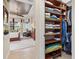 Bedroom view from walk-in closet, featuring custom shelving and storage with views of the bright bedroom at 13644 Brilliante Dr, Venice, FL 34293