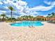Stunning community pool with inviting clear blue water, surrounded by brick pavers, palm trees and comfortable lounge chairs at 13644 Brilliante Dr, Venice, FL 34293