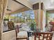 Dining area with glass table and view of the screened-in pool and patio at 13644 Brilliante Dr, Venice, FL 34293