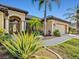 Inviting home exterior with manicured landscaping and a charming front entrance at 13644 Brilliante Dr, Venice, FL 34293