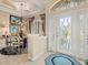 Foyer area featuring a decorative light fixture, high ceilings, and a glass entry door at 13644 Brilliante Dr, Venice, FL 34293