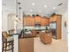 Kitchen featuring stainless steel appliances, an island, granite counters, and bar seating at 13644 Brilliante Dr, Venice, FL 34293