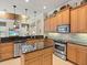 Kitchen featuring an island, stainless steel appliances, and granite counters at 13644 Brilliante Dr, Venice, FL 34293