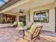 Paver lanai with lounge chairs and tables providing outdoor seating with a view at 13644 Brilliante Dr, Venice, FL 34293