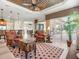 Open-concept living room with tile flooring, plantation shutters, and stylish furnishings, providing a comfortable and inviting space at 13644 Brilliante Dr, Venice, FL 34293