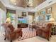 Comfortable living room with decorative ceiling, warm lighting, and decorative art at 13644 Brilliante Dr, Venice, FL 34293
