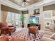 Bright living room featuring decorative ceiling, ample natural light, stylish furnishings, and tiled flooring at 13644 Brilliante Dr, Venice, FL 34293