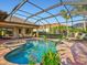 Screened pool area with a pool, spa, and seating, perfect for relaxation and entertaining at 13644 Brilliante Dr, Venice, FL 34293