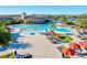 Aerial view of the resort-style pool featuring lounge chairs and umbrellas at 13644 Brilliante Dr, Venice, FL 34293