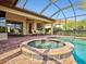 Screened lanai with a luxurious pool and spa area and views into the lush yard at 13644 Brilliante Dr, Venice, FL 34293