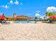 Large resort-style pool with beach-like entry and a splash fountain at 13644 Brilliante Dr, Venice, FL 34293