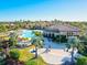 Aerial view of a large pool featuring beach area and lounge chairs at 13644 Brilliante Dr, Venice, FL 34293