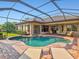 Inviting screened-in pool with spa and brick patio, perfect for relaxing and entertaining at 13644 Brilliante Dr, Venice, FL 34293