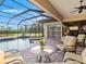 Beautiful lanai with a pool, spa, and comfortable seating for outdoor relaxation at 13644 Brilliante Dr, Venice, FL 34293