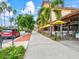 Sidewalk street view with dining areas, retail, and palm trees at 13644 Brilliante Dr, Venice, FL 34293