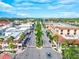 Aerial view of a quaint street lined with palm trees and buildings at 13644 Brilliante Dr, Venice, FL 34293