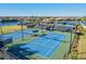 Well-maintained tennis courts with a view of the neighborhood and lake at 13644 Brilliante Dr, Venice, FL 34293