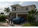 Modern two-story home with a balcony, garage, and well-manicured front lawn at 1423 S Shade Ave, Sarasota, FL 34239