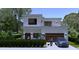 Rendering of a modern two-story home with a balcony, garage, and landscaped front yard at 1423 S Shade Ave, Sarasota, FL 34239