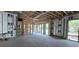 Unfinished living room with exposed framing, in-wall wiring, and sliding glass door showing construction progress at 1423 S Shade Ave, Sarasota, FL 34239