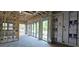 Unfinished living room with exposed beams, windows and sliding glass doors to backyard at 1423 S Shade Ave, Sarasota, FL 34239
