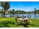 Inviting backyard with waterfront views, dock, and an outdoor dining set at 1542 Gulfview Dr, Sarasota, FL 34236