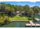 Waterfront home with lush grassy yard, private dock, and outdoor seating area, perfect for entertaining at 1542 Gulfview Dr, Sarasota, FL 34236