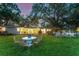 Serene backyard with inviting outdoor dining area and plenty of space for relaxation by the waterfront at 1542 Gulfview Dr, Sarasota, FL 34236