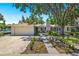 Charming single-story home with a two-car garage, a well-manicured lawn, and tasteful landscaping at 1542 Gulfview Dr, Sarasota, FL 34236