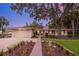 Beautiful one-story home with a driveway, lush landscaping, and mature trees at 1542 Gulfview Dr, Sarasota, FL 34236
