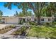 Charming single-story home with a two-car garage, a well-manicured lawn, and tasteful landscaping at 1542 Gulfview Dr, Sarasota, FL 34236