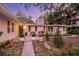 Inviting front entrance with a decorative door, lush landscaping, and manicured lawn at 1542 Gulfview Dr, Sarasota, FL 34236