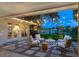 Inviting outdoor patio with waterfront view, string lights, and comfortable seating for relaxing and entertaining at 1542 Gulfview Dr, Sarasota, FL 34236