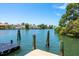 Beautiful waterfront view with a private dock and lush green landscaping at 1542 Gulfview Dr, Sarasota, FL 34236