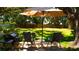 Relaxing backyard featuring a patio area with chairs, umbrella, grill, and lush green lawn at 1613 6Th W St, Palmetto, FL 34221