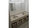 Bathroom featuring a double sink vanity, decorative storage baskets, and modern fixtures at 1613 6Th W St, Palmetto, FL 34221