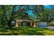 Charming single-story home features a lush, green lawn and mature, shady trees at 1613 6Th W St, Palmetto, FL 34221