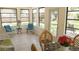 Charming sunroom with tile flooring, large windows, and comfortable seating, perfect for relaxation at 1613 6Th W St, Palmetto, FL 34221