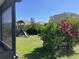 View of backyard with playset and lush greenery from screened-in porch at 16919 Trite Bend St, Wimauma, FL 33598
