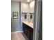 Bathroom with modern vanity featuring double sinks and decorative towel racks with mounted decor accents at 16919 Trite Bend St, Wimauma, FL 33598