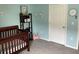 Bedroom with a crib, shelves, decorations, and light from the window at 16919 Trite Bend St, Wimauma, FL 33598